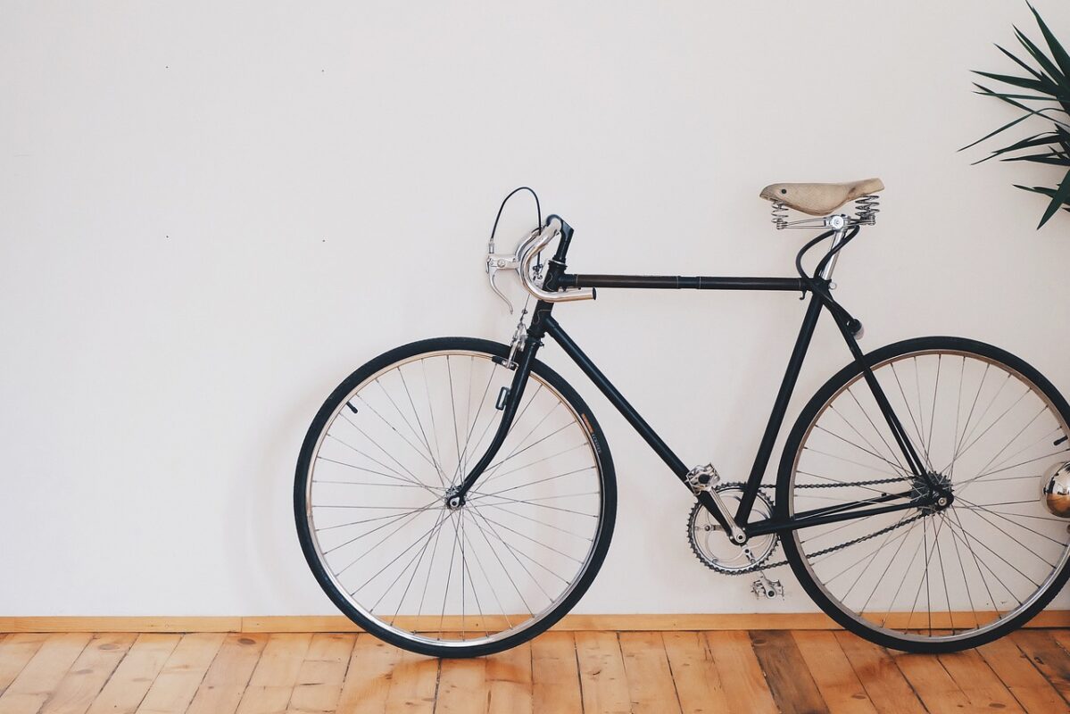 A bicycle stored vertically on a wall rack