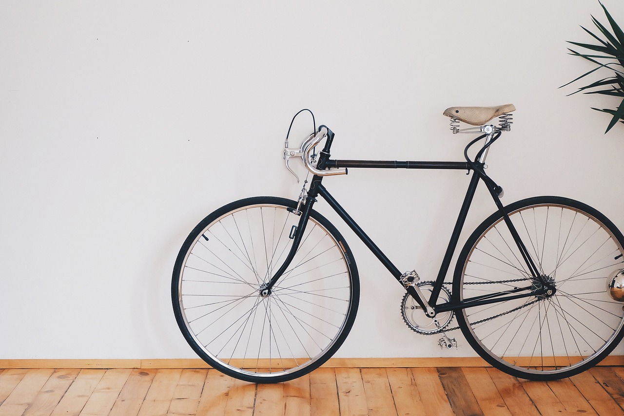 A bicycle stored vertically on a wall rack